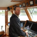 Peter Schaefer at the helm of Flying Colours as we take her through the Ballard Locks and into salt water.