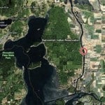 The Swinomish Channel is the thin ribbon snaking from bottom to top in this Bing satellite image (with the red circle just north of La Conner). Highway 20 leading into Anacortes runs left across the top.