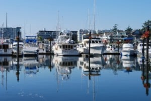 Flying Colours at slip E-6 at Port Sidney Marina, with the downtown buildings in the background.