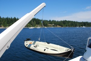 Ron's inflatable kayak being lowered by the davit.