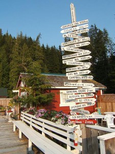 Sullivan Bay mileage sign.  Notice the bottom one - two steps to the Happy Hour - just to the right of this is a special float with deck chairs and tables where the nightly Happy Hour is held.