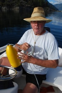 Steve readies the buoy that will mark where their prawn pot has been set.