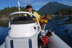 It’s Kap’s turn to drive the dinghy for the shore visit, with Gator and Raz riding shotgun.