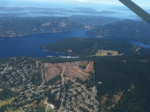 We passed by Maple Bay (center of photo, with the marina), a marina we stayed at two years ago and really enjoyed it.  In the upper half of the photo is Saltspring Island, with Burgoyne Bay almost splitting it into two islands.  At the lower half is the town of Maple Bay – note the terraced mining area just across the ridge from the marina, with houses built right to the edge of it.