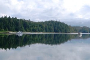 An abandoned First Nations village is market by "midden" shell beach that shows up white behind the Nordic Tug at anchor.